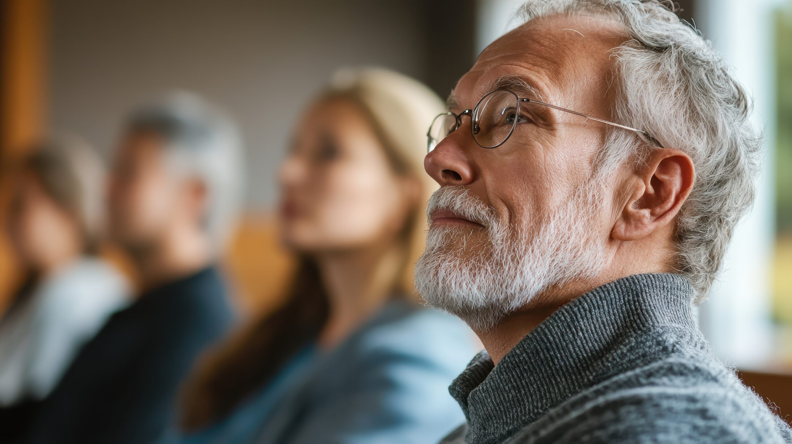 Wealthy older man in seminar listening to information about how he can protect his estate for his family and loved ones