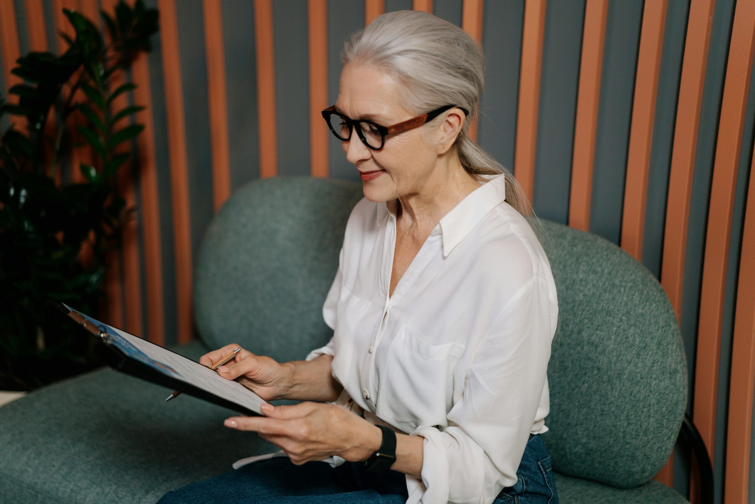 older woman looking at her insurance options online and smiling