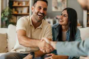 Strong Client Relationships: Retention Strategies showing a young happy couple and an insurance agent meeting again over long lasting professional relationship