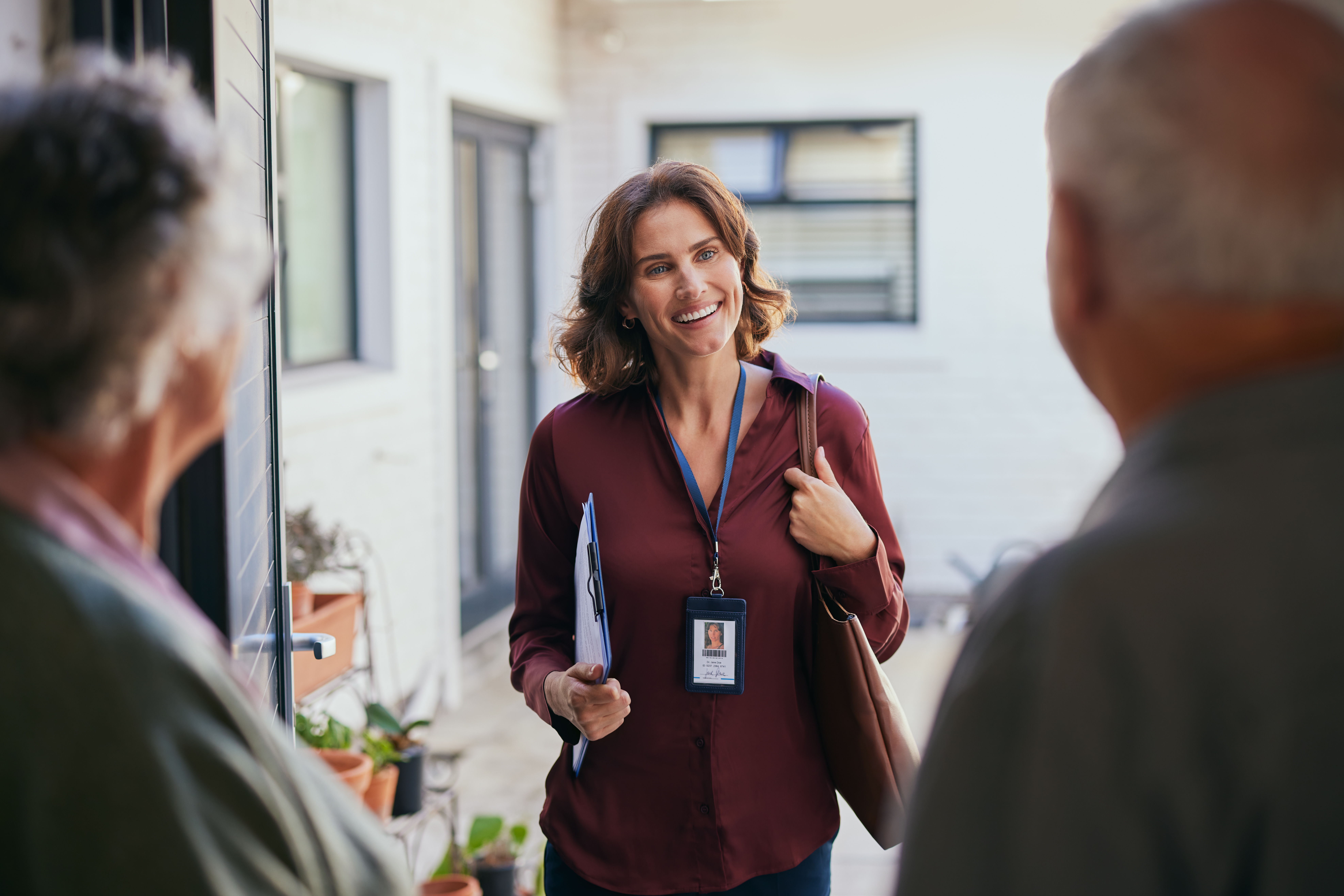 Medicare agent greeting couple at the door to walk them through plan options